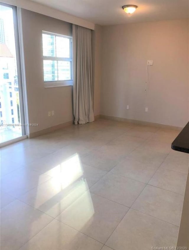 spare room featuring light tile patterned floors