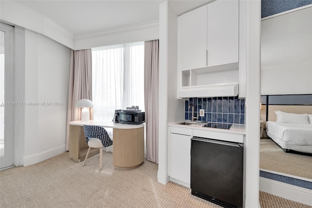 carpeted home office with ornamental molding and sink