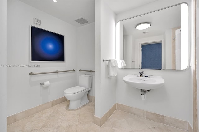 bathroom with tile patterned flooring, toilet, and sink