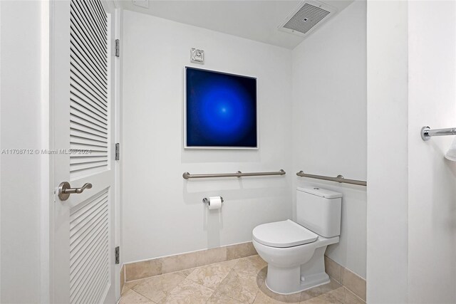 bathroom with tile patterned flooring and toilet