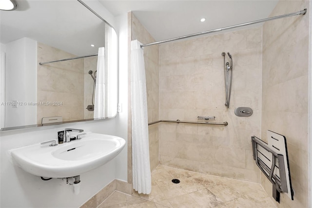 bathroom with tile patterned flooring, curtained shower, and sink