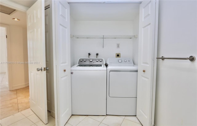 laundry area with light tile patterned flooring and washing machine and clothes dryer