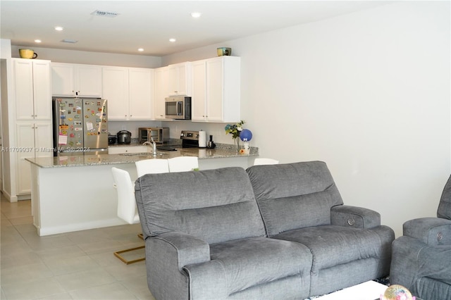 tiled living room featuring sink