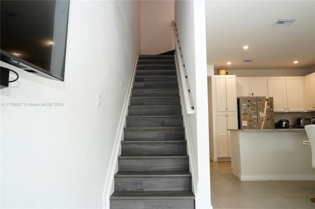 staircase with tile patterned flooring