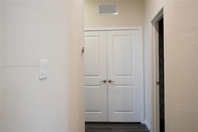 corridor with dark hardwood / wood-style flooring