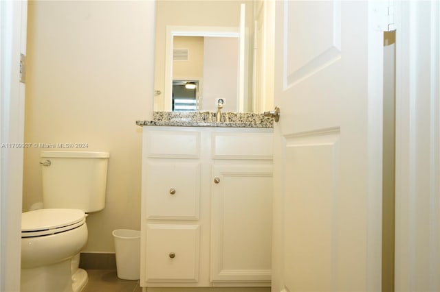 bathroom with tile patterned floors, vanity, and toilet