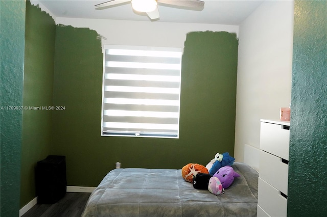 bedroom featuring ceiling fan and dark wood-type flooring