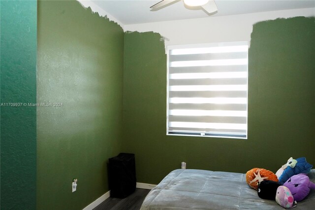 bedroom with ceiling fan and wood-type flooring