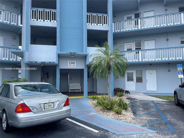 view of building exterior with uncovered parking