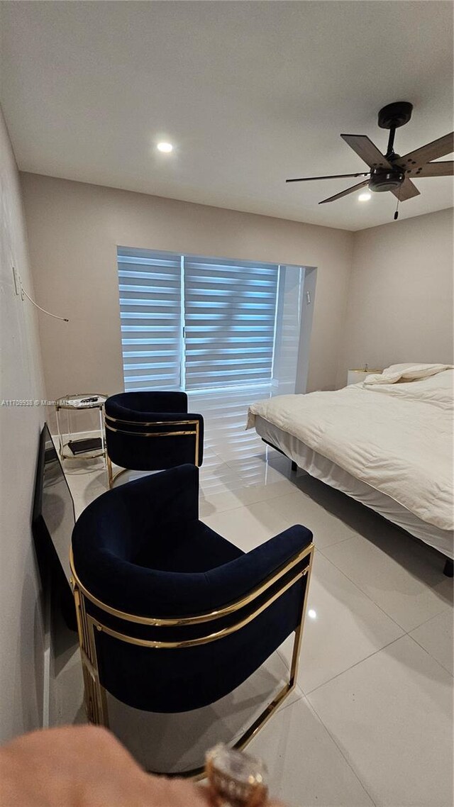 tiled bedroom featuring ceiling fan