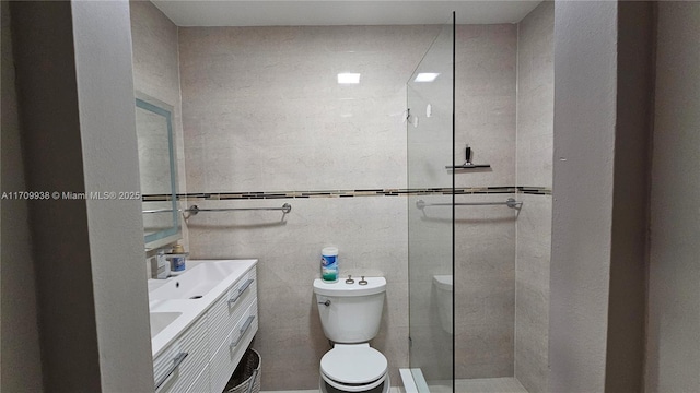 full bath featuring a walk in shower, double vanity, a sink, and toilet