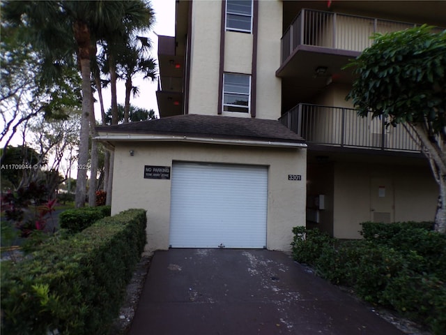 view of garage at dusk