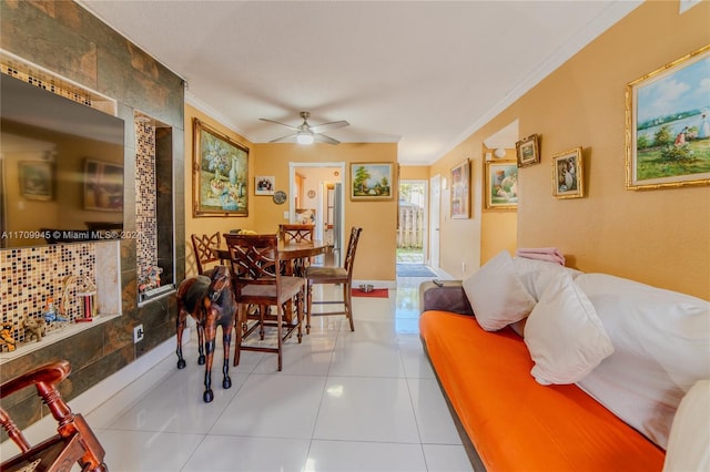 dining space with ceiling fan, crown molding, and light tile patterned floors