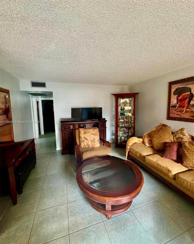 living room featuring tile patterned flooring and a textured ceiling