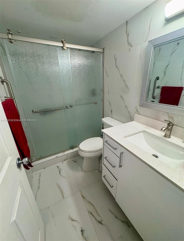 bathroom featuring walk in shower, vanity, and toilet