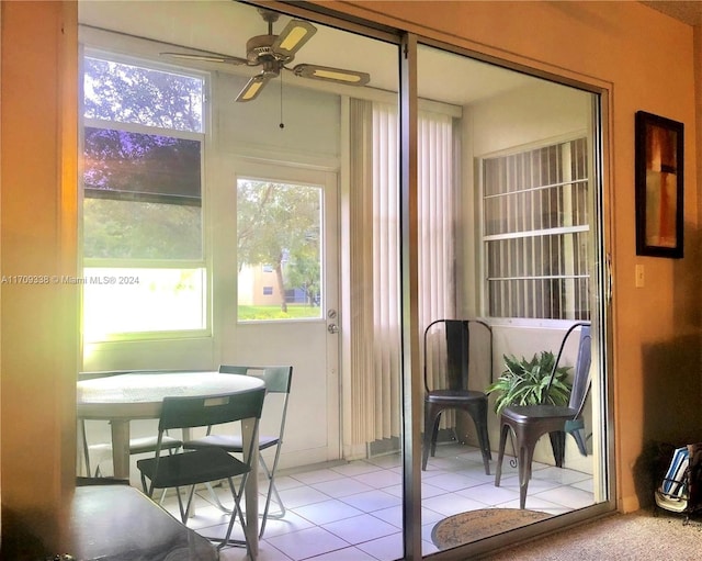 sunroom featuring a wealth of natural light and ceiling fan