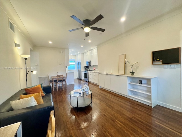 living room with ceiling fan, crown molding, and dark hardwood / wood-style floors