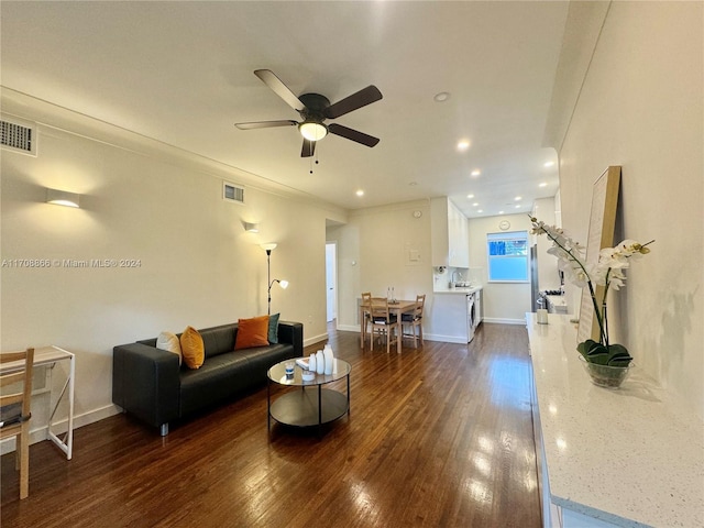 living room featuring ceiling fan and dark hardwood / wood-style floors