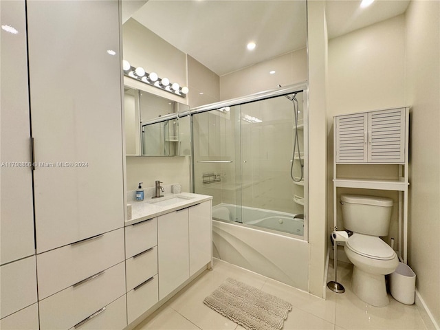 full bathroom with toilet, vanity, tile patterned floors, and shower / bath combination with glass door