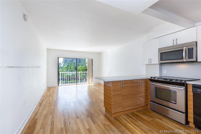 kitchen with white cabinets, stainless steel appliances, and light hardwood / wood-style floors