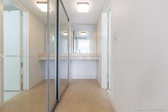 hall featuring light tile patterned floors