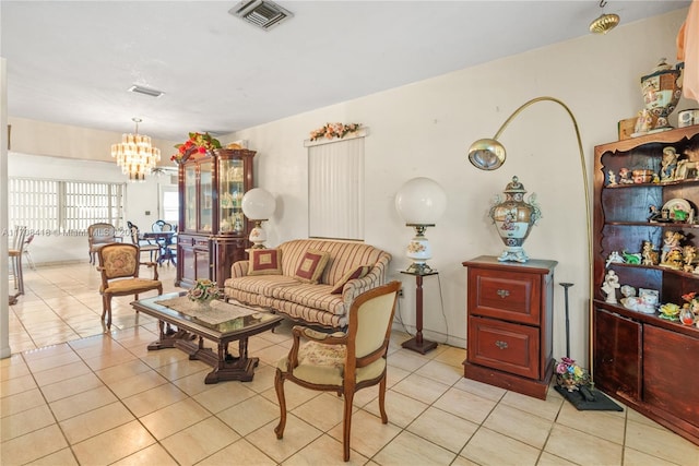 tiled living room with a notable chandelier