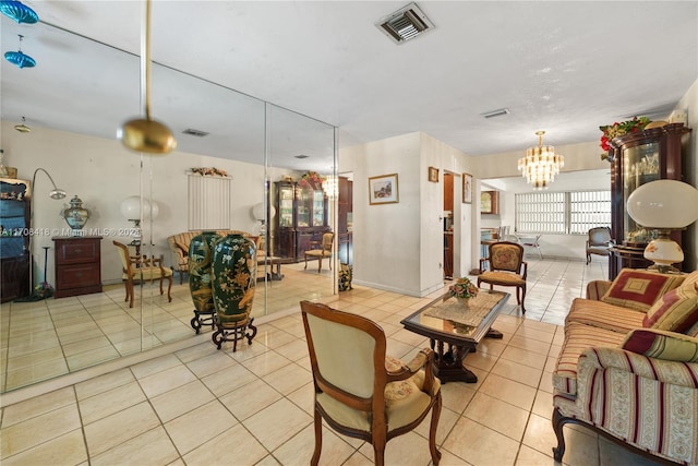 living room with a notable chandelier and light tile patterned flooring