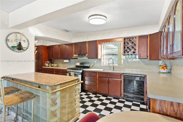 kitchen with kitchen peninsula, sink, dishwasher, a breakfast bar area, and stainless steel range with gas stovetop