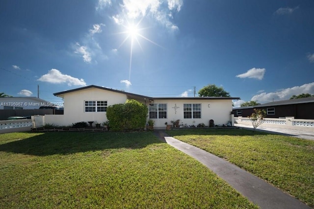 single story home featuring a front yard