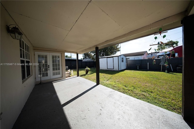 view of patio / terrace with french doors and a storage unit