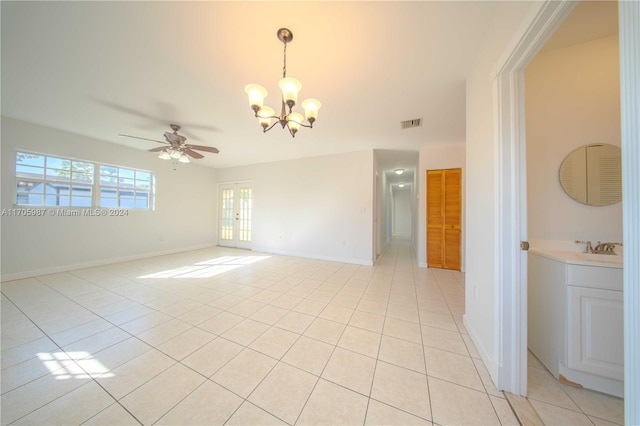 spare room with light tile patterned floors and ceiling fan with notable chandelier