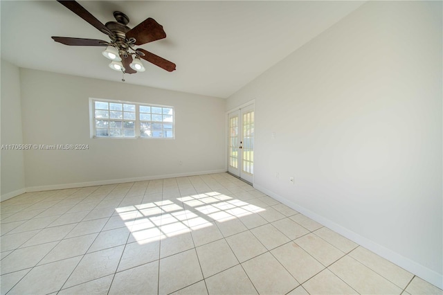 tiled spare room with french doors and ceiling fan