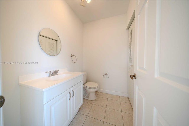 bathroom featuring tile patterned floors, vanity, and toilet