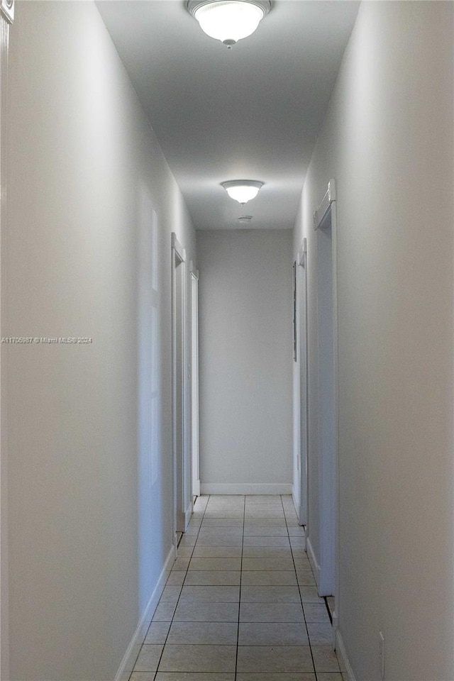 corridor featuring light tile patterned floors