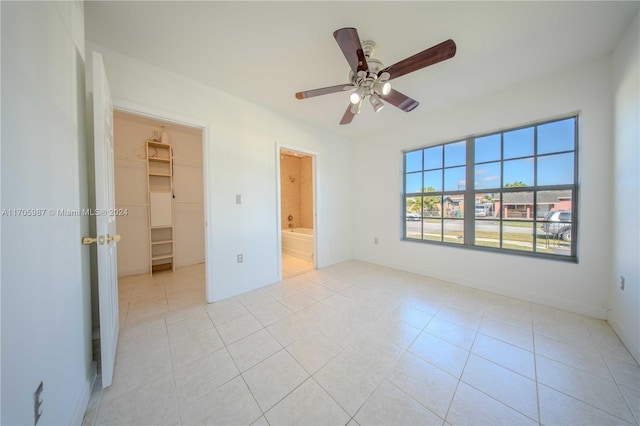 empty room featuring ceiling fan and light tile patterned flooring