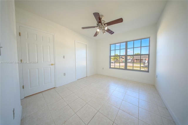 unfurnished bedroom with ceiling fan and light tile patterned flooring