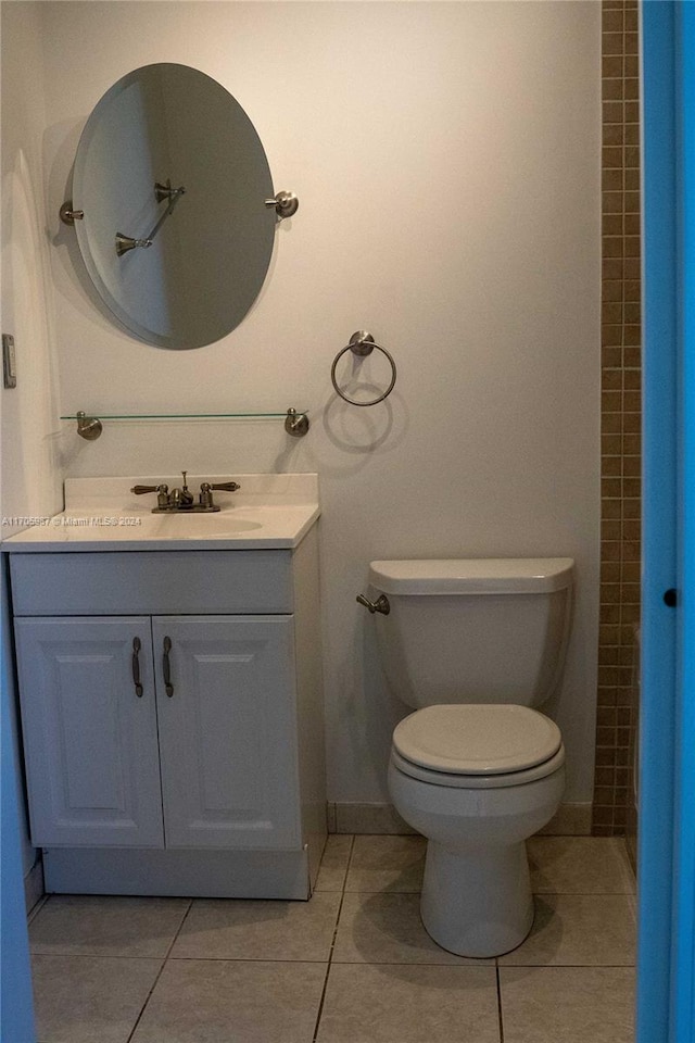 bathroom featuring toilet, vanity, and tile patterned floors