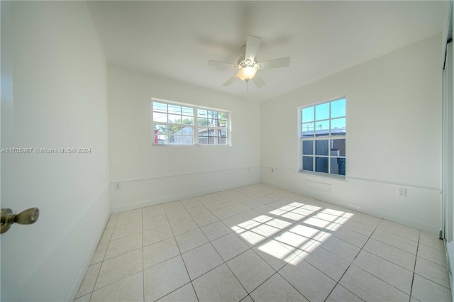 unfurnished room with ceiling fan and light tile patterned flooring