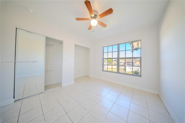 unfurnished bedroom featuring light tile patterned floors and ceiling fan