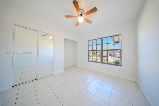 unfurnished bedroom featuring ceiling fan and light tile patterned floors