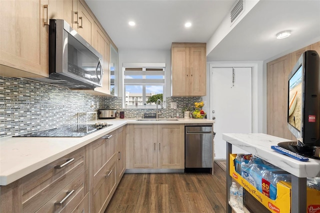 kitchen featuring light brown cabinetry, dark hardwood / wood-style flooring, sink, and stainless steel appliances