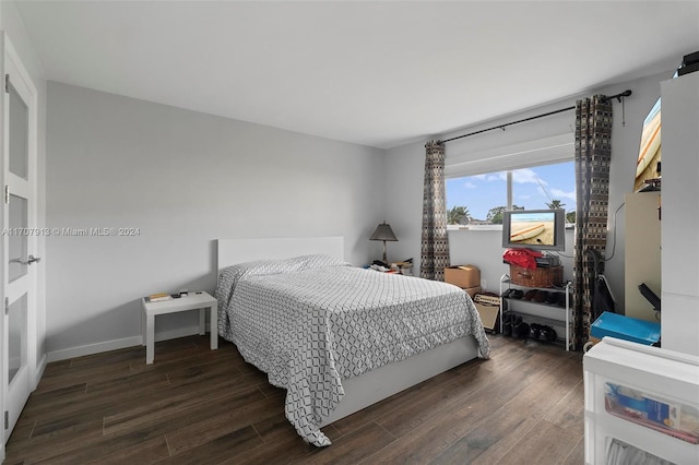 bedroom with dark wood-type flooring