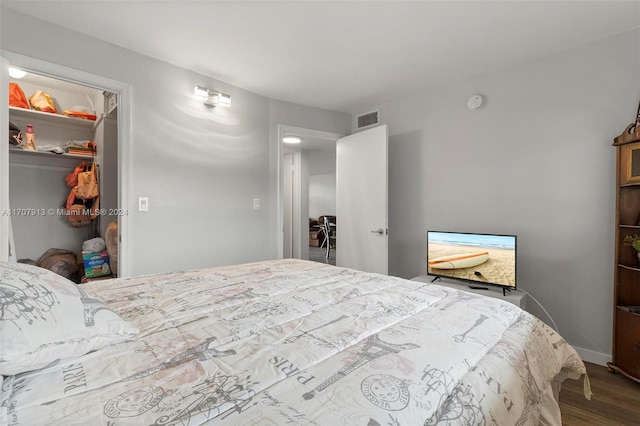 bedroom featuring wood-type flooring and a closet