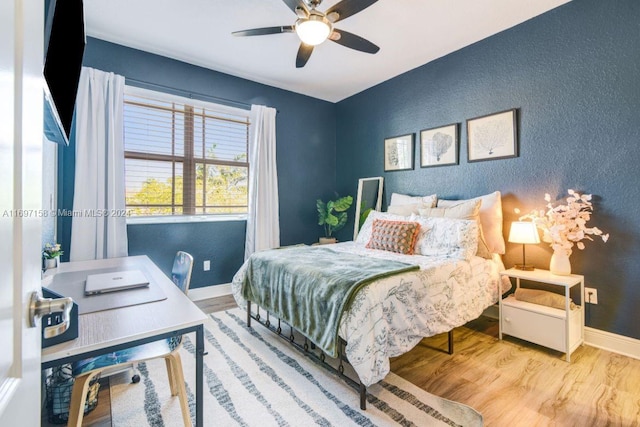 bedroom featuring hardwood / wood-style floors and ceiling fan