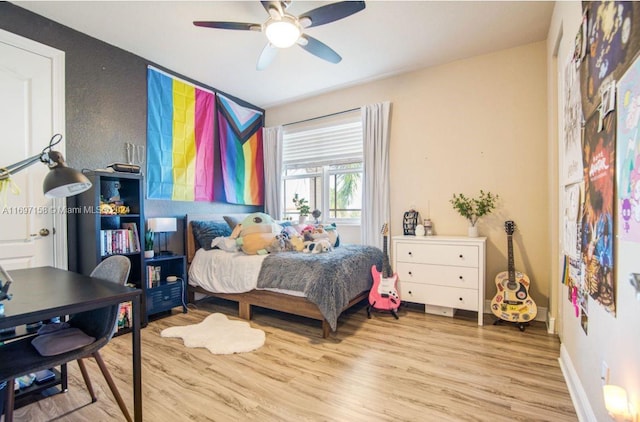 bedroom with light hardwood / wood-style flooring and ceiling fan