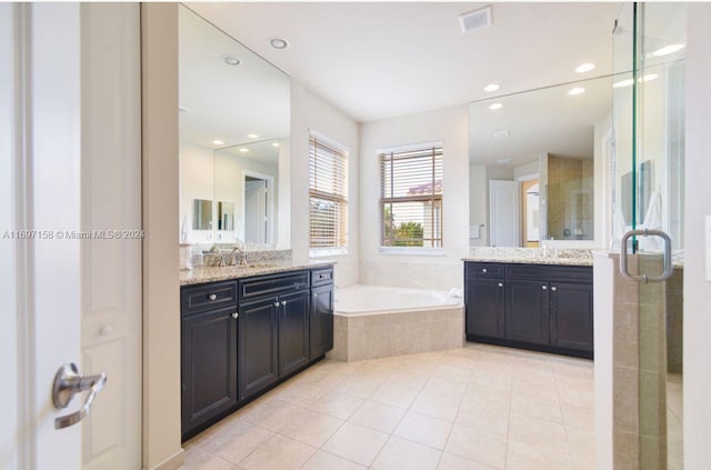 bathroom with tile patterned floors, vanity, and separate shower and tub