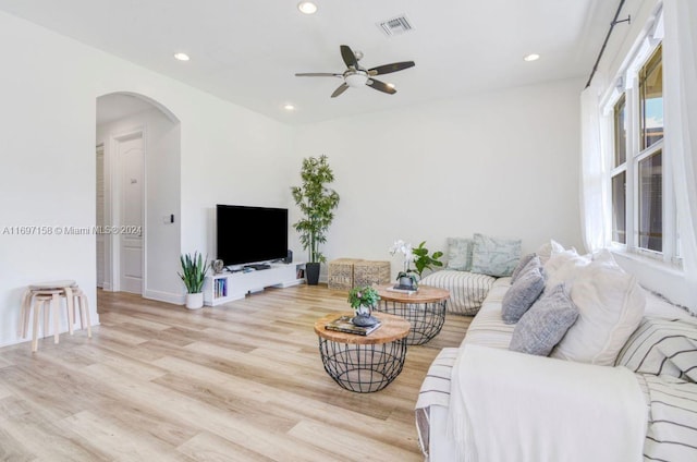 living room with ceiling fan and light hardwood / wood-style floors