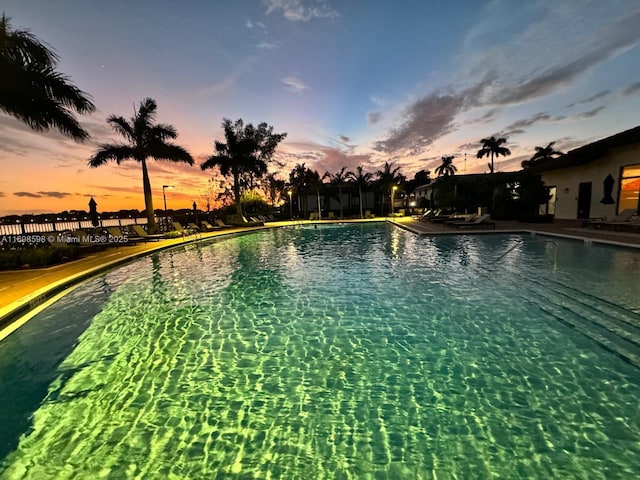 view of pool at dusk