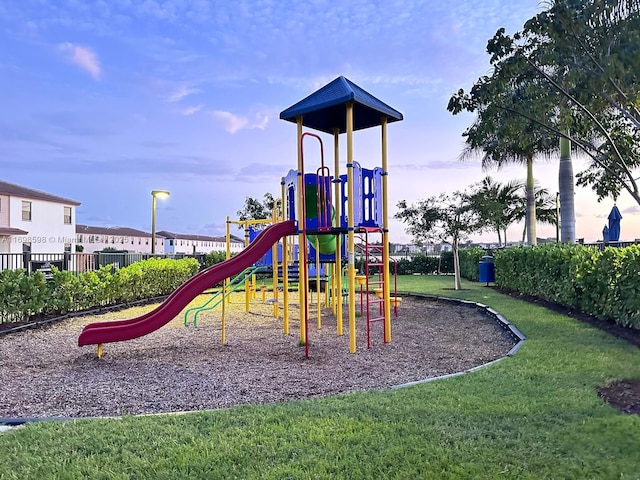 view of jungle gym with a lawn