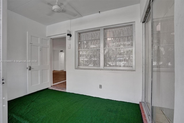 unfurnished room with ceiling fan and carpet floors